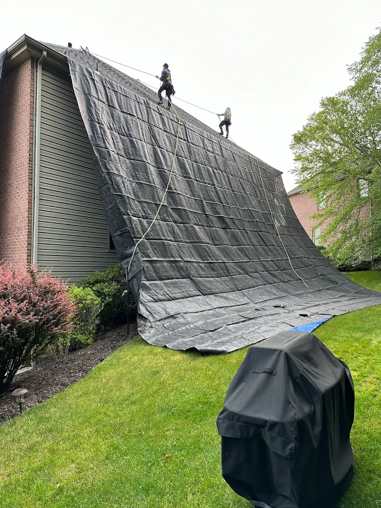 Aerial view of a large house with a new roof installation.