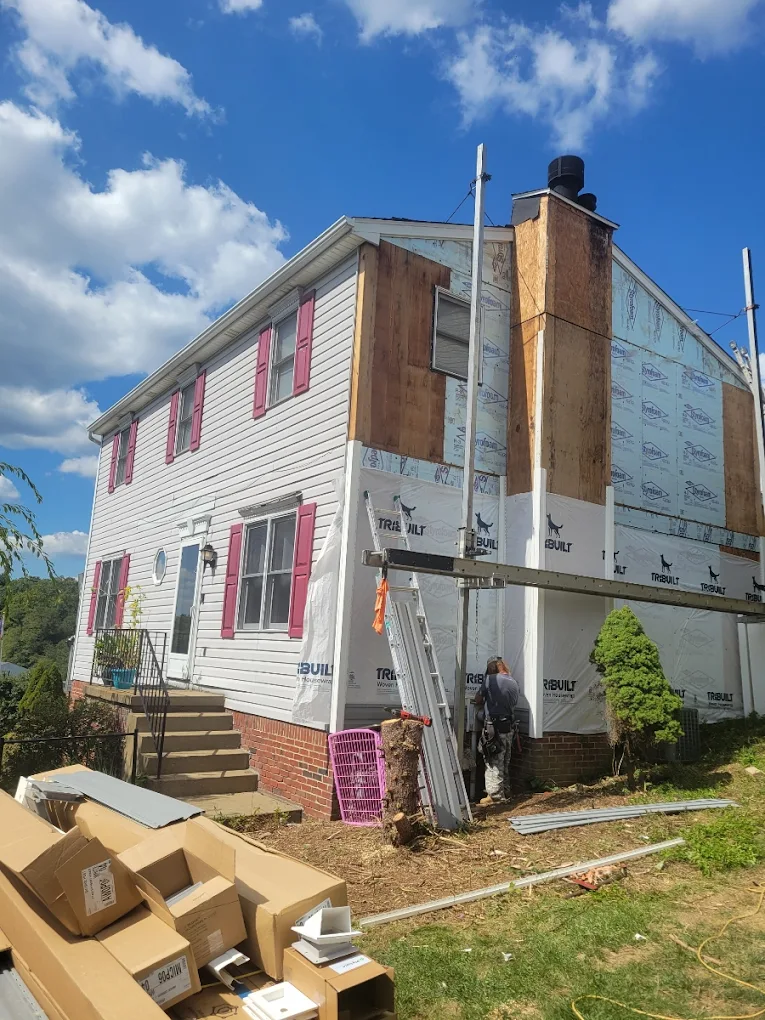 White house with gray siding and a small front porch.